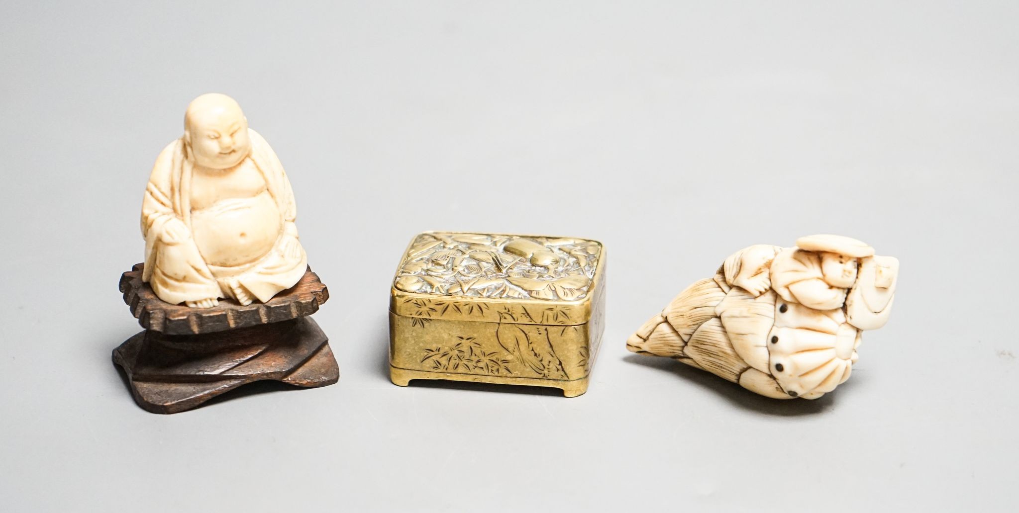 19th-century Japanese Ivory netsuke a man on a bamboo shoot, an ivory figure of Budai and a Japanese embossed brass box 5cm